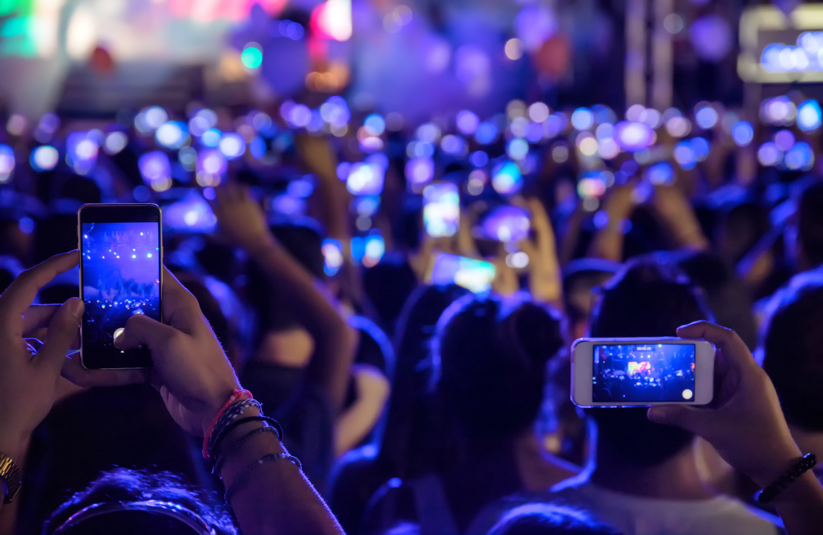 people filming at a concert